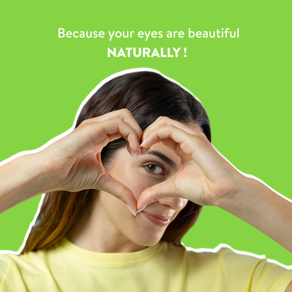 Woman making a heart shape with her hands against a green background with text 'Because your eyes are beautiful NATURALLY!'.