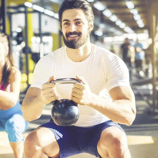 Healthy man holding dumbbells during a strength training workout, showcasing fitness, discipline, and an active lifestyle.