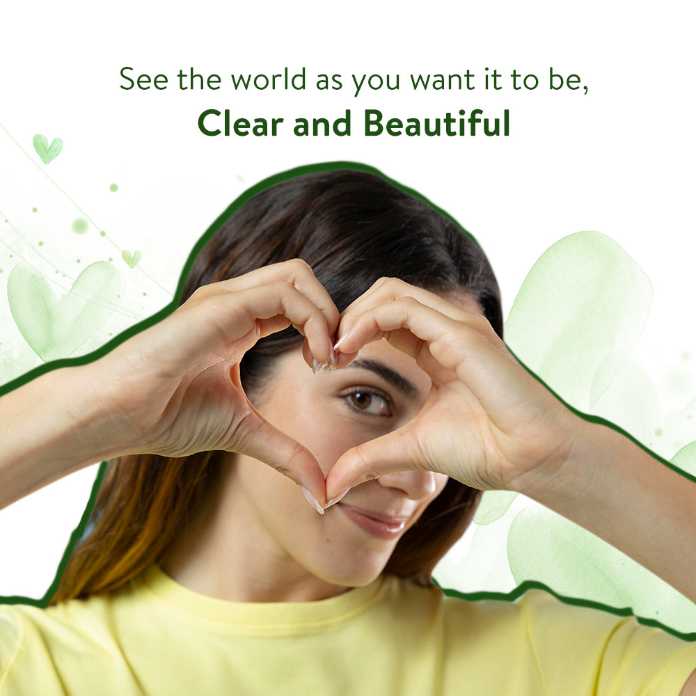 A girl forms a heart shape around one of her eyes with her hands. The image text reads, 