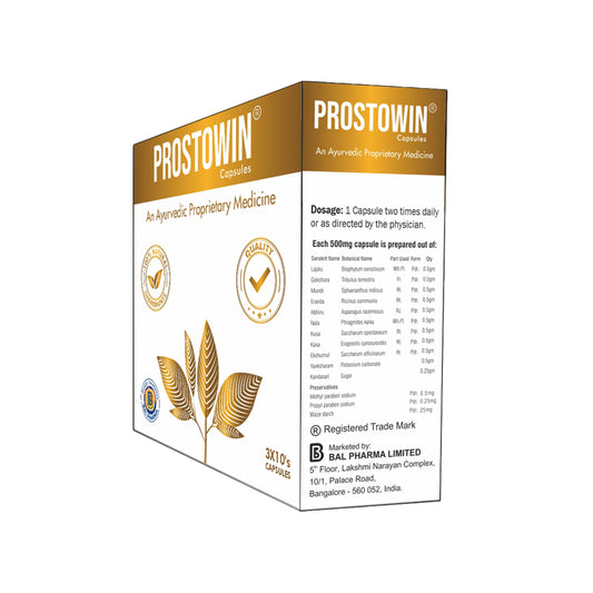 A box of Prostowin capsules, an Ayurvedic proprietary medicine, shown on a clean white background. The packaging features a golden and white color scheme with gold foil accents, including a stylized golden lotus flower.